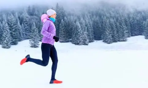 woman running in the snow