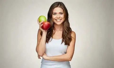 woman holding green and red apples