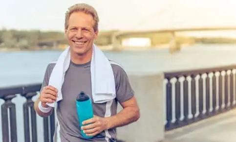 man jogging holding a water bottle