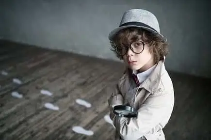 little kid with curly hair wearing a glass and a hat