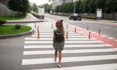 young girl crossing the pedestrian lane