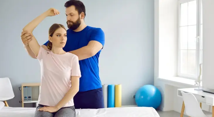 chiropractor-adjusts-woman-s-shoulder