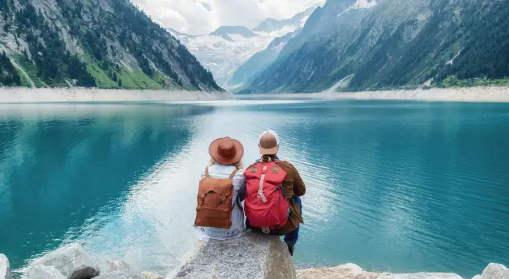 man-and-woman-sit-by-lake