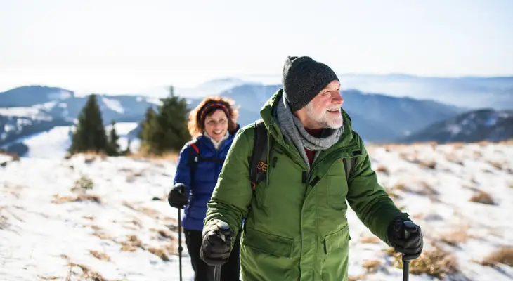 old-couple-goes-for-snowy-hike