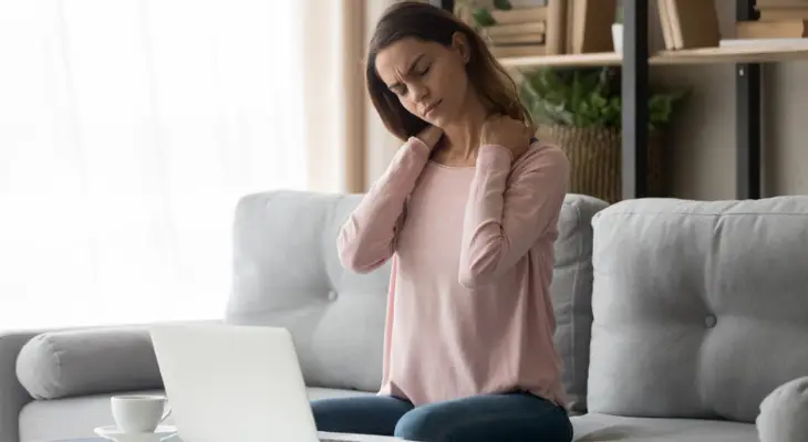 woman-experiences-neck-pain-from-working-on-her-couch