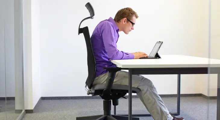 young-man-hunched-over-laptop